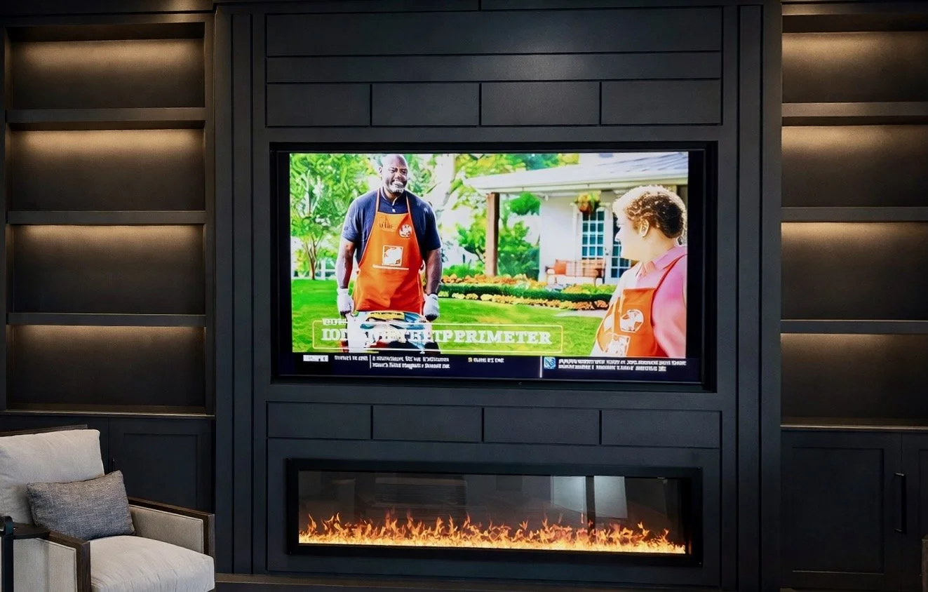 floating shelves with LED lighting on custom media wall