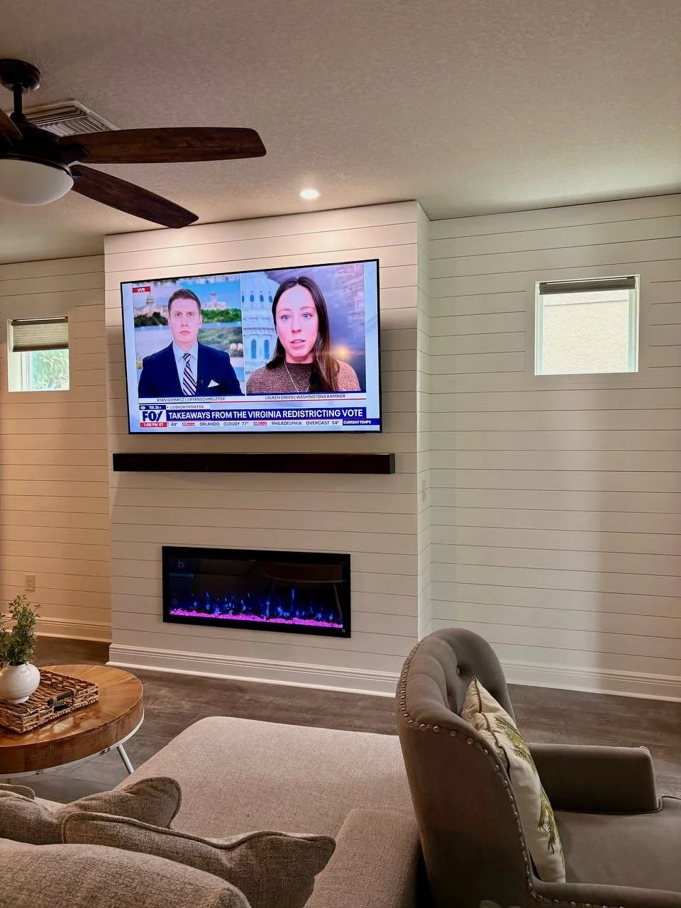 Angle view of shiplap TV wall with fireplace in Tampa Bay home