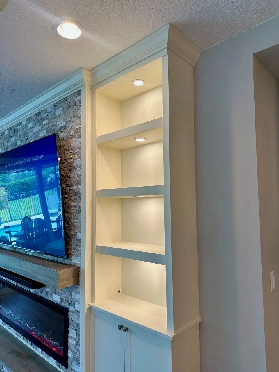 Custom built-in shelving with recessed lighting and crown molding detail in Cocoa Beach Florida