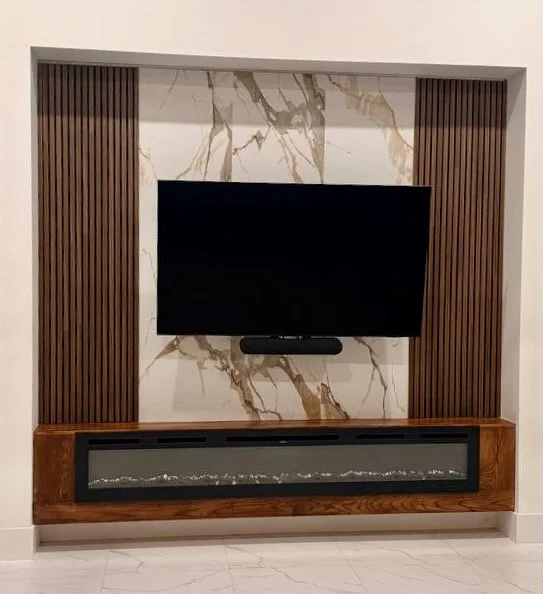 Close-up of electric fireplace and floating cabinet in media wall