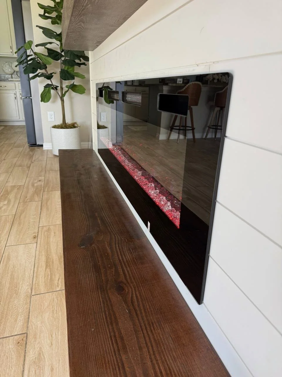 A close side view highlighting the elegant contrast between the dark-stained wood bench and the clean white horizontal shiplap finish.