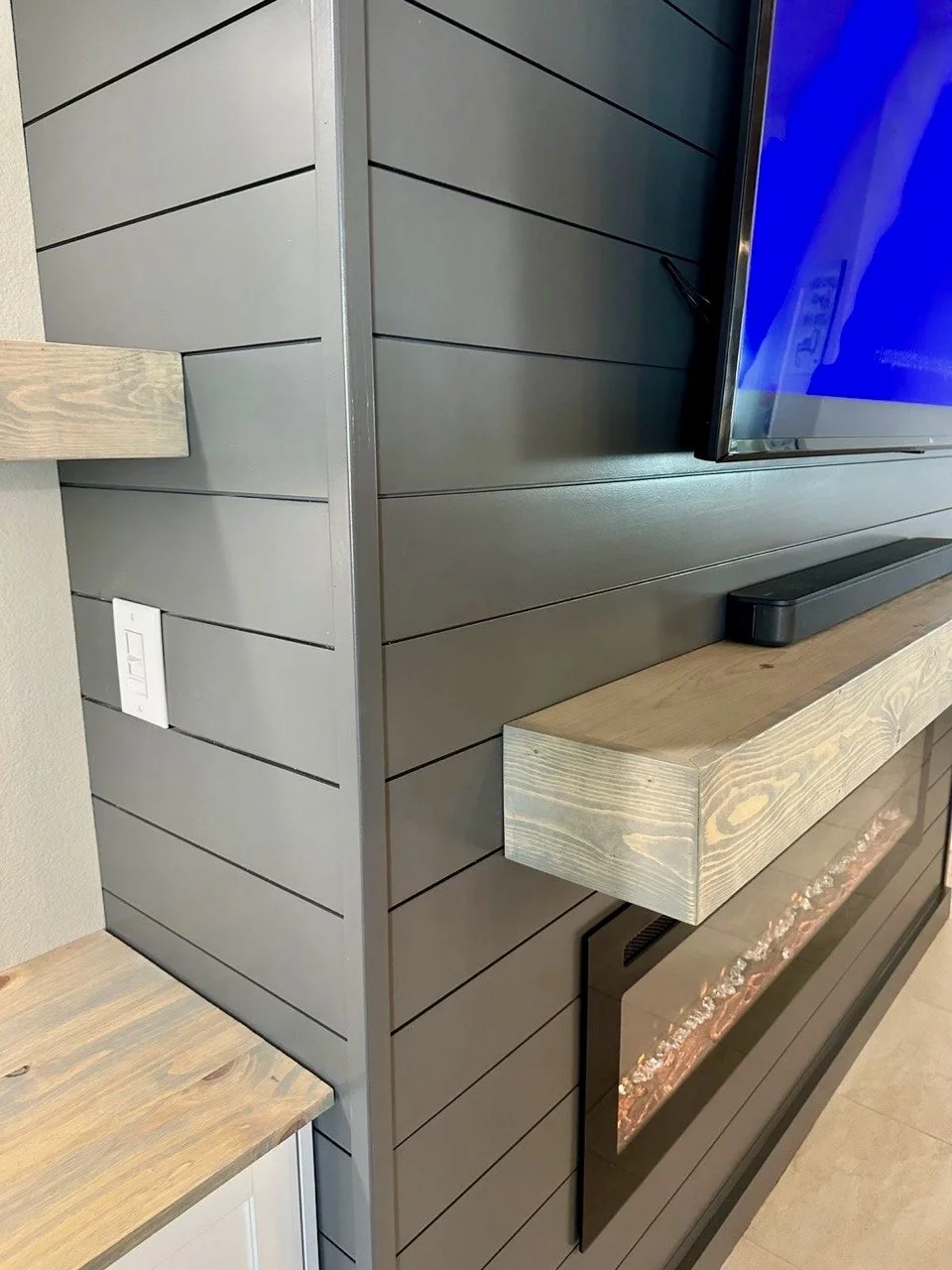 shiplap wall paneling with precise trim and painted finish on custom media wall