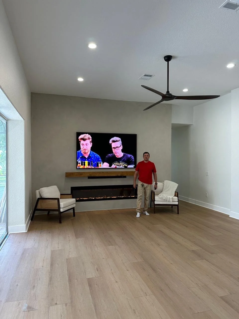 wide living room with modern tv wall and fireplace in Sarasota Bradenton home