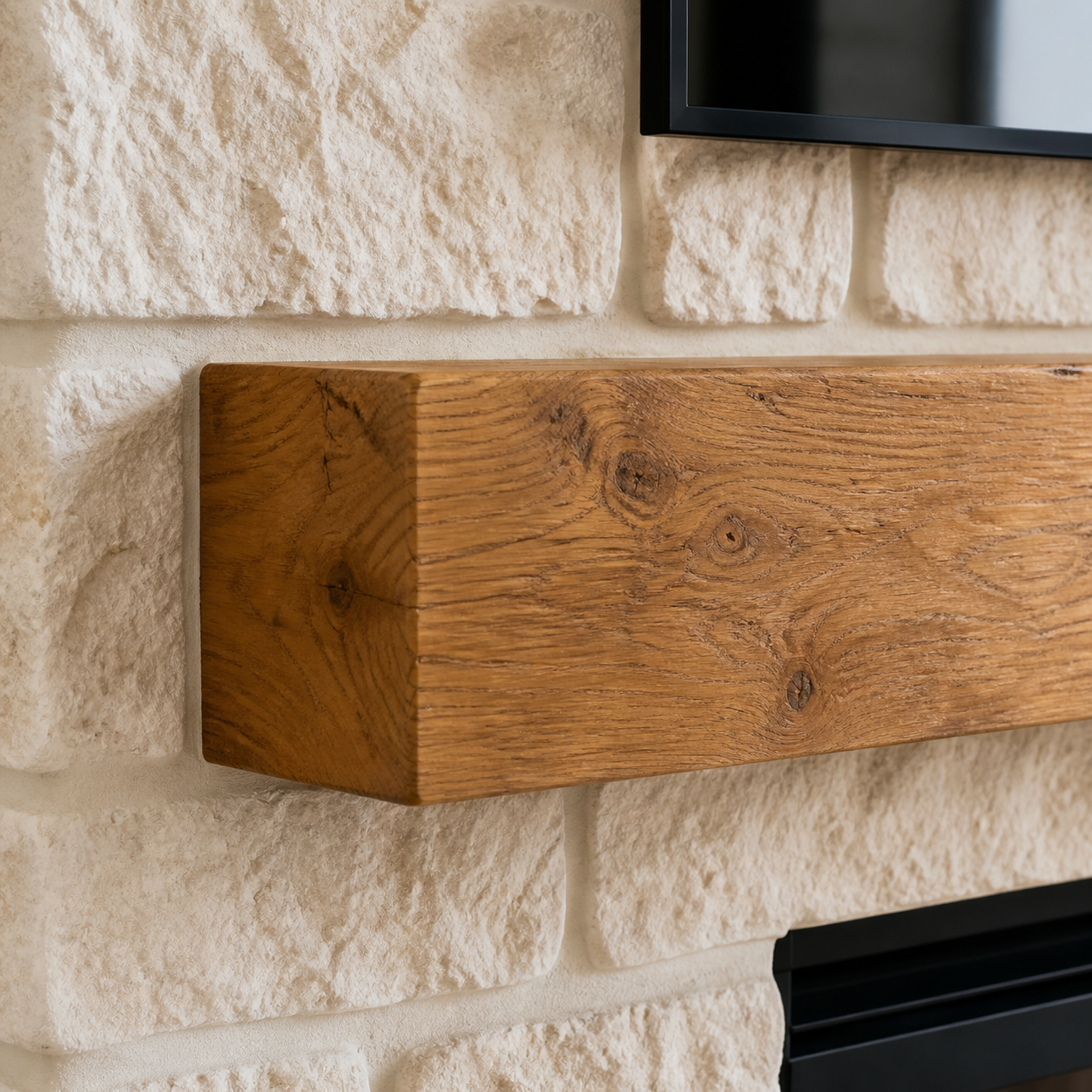 Natural oak fireplace mantel installed against textured Rough Cut Stone veneer
