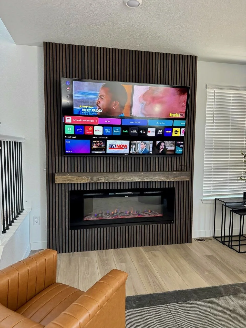 slat fireplace media wall design in Palm Beach area with custom wood mantel