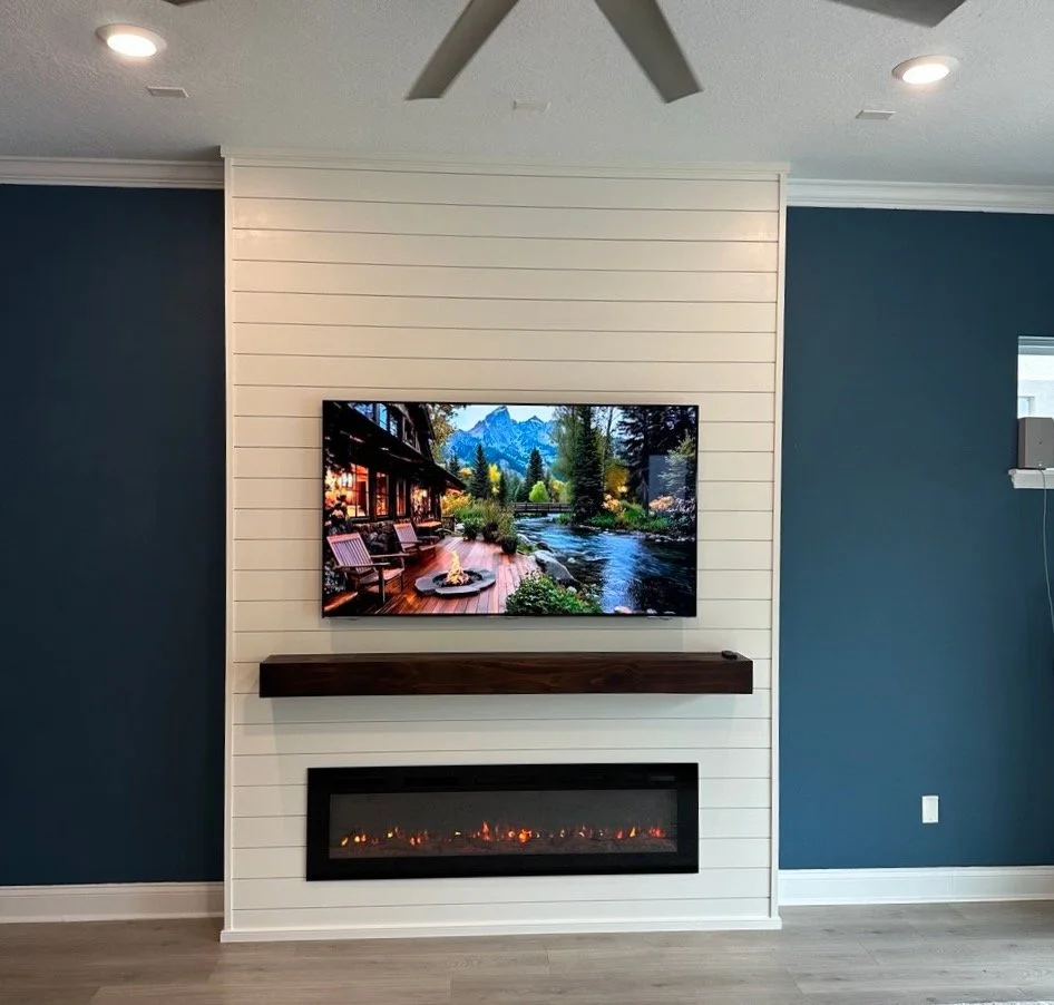 Custom shiplap fireplace media wall with modern mantel and electric fireplace installation in Orlando living room.