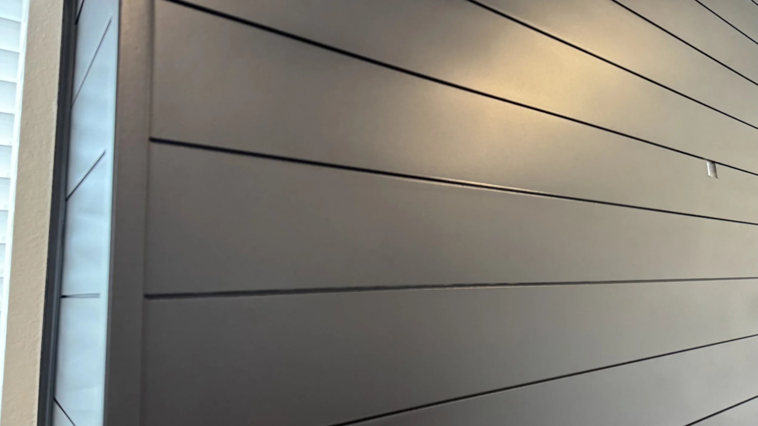 Sarasota_Detail of Spray-Painted Black Shiplap Panels.jpeg