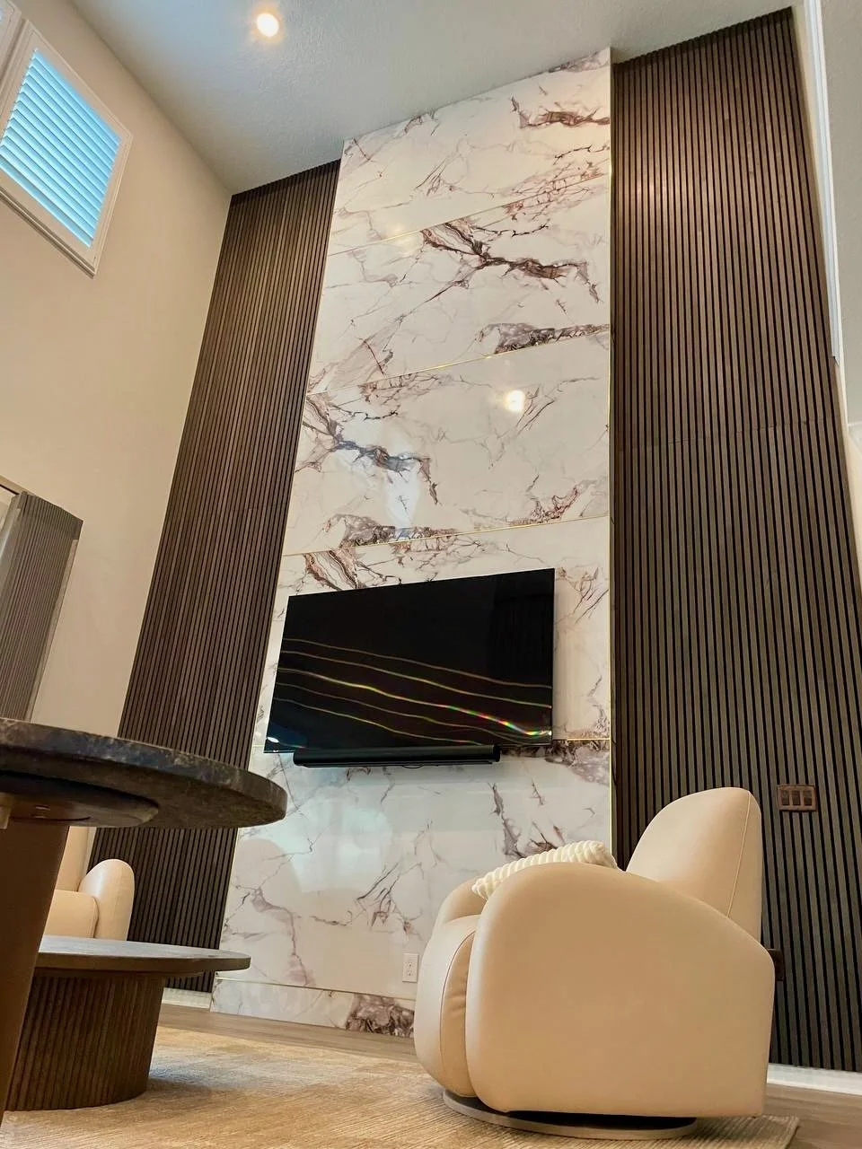 High Ceiling Marble Slab Media Wall with Wood Slats in Winter Garden, Orlando