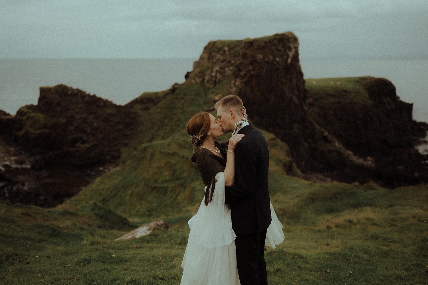 isle of skye elopement photography brothers point ceremony bride and groom first kiss