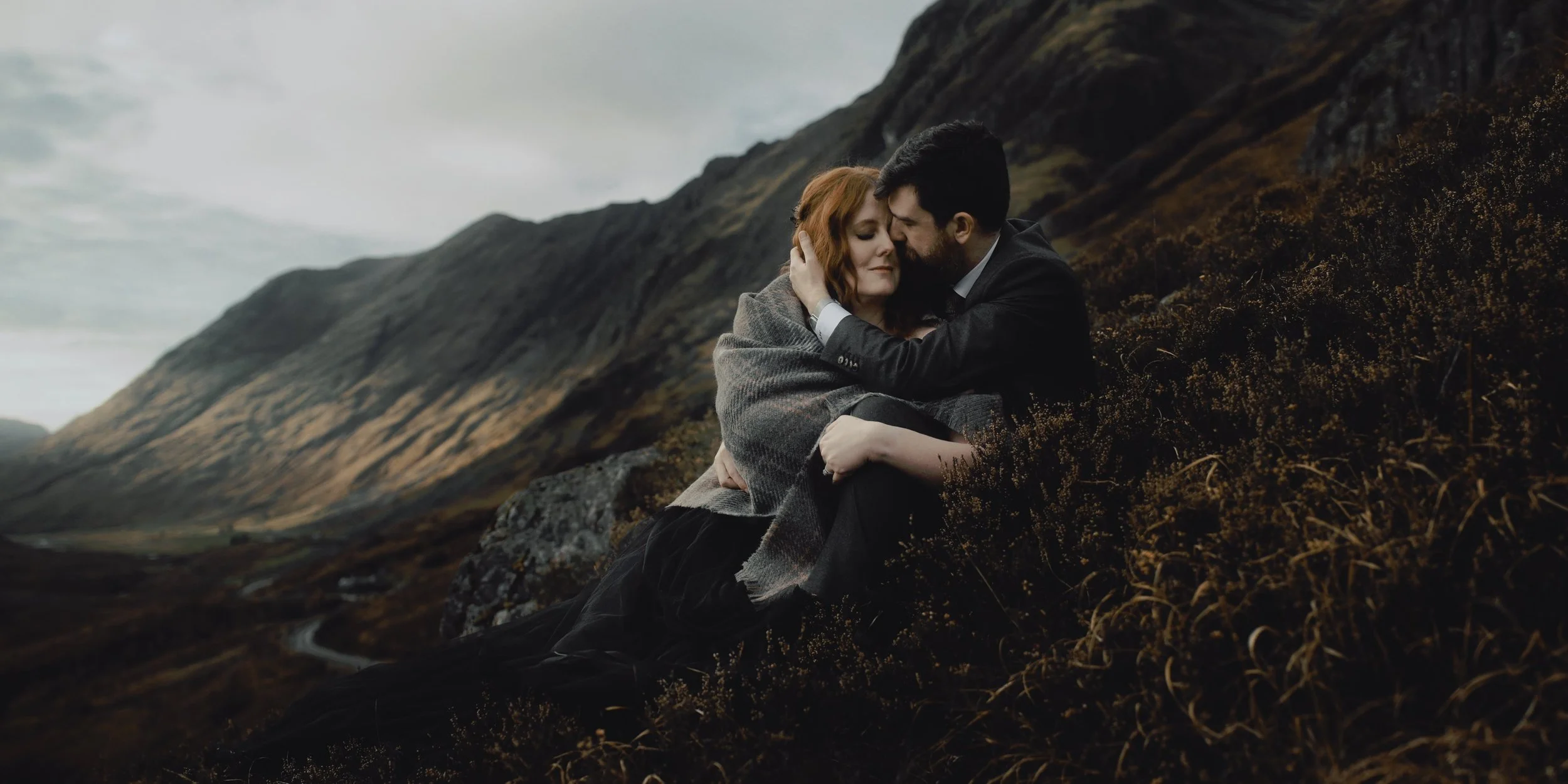 glencoe elopement photography bride and groom embracing on hillside ralston cairn viewpoint
