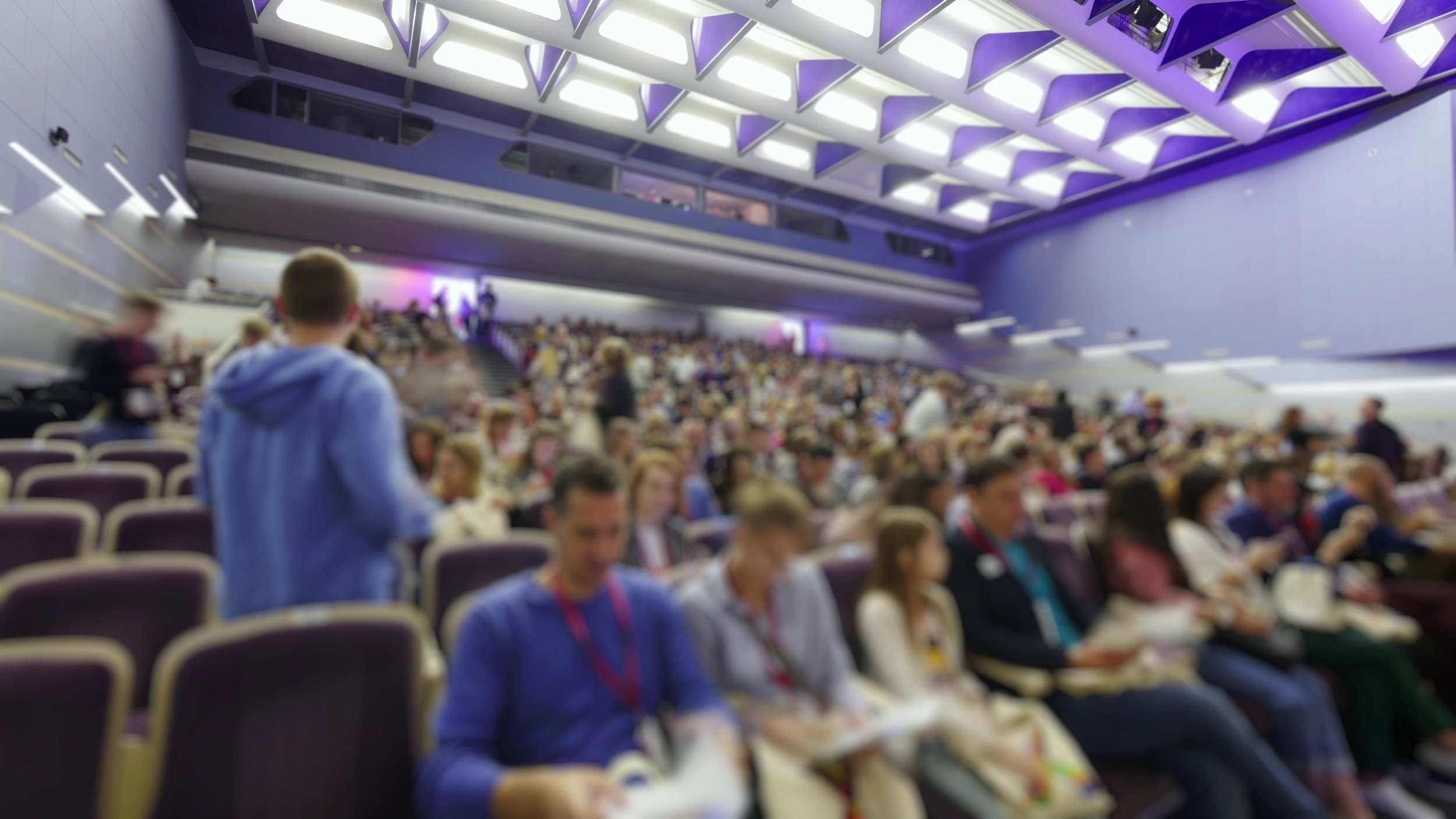 timelapse-concept-crowd-coming-to-conference-large-hall-sitting-on-the-places-talking--SBI-349589134.jpg