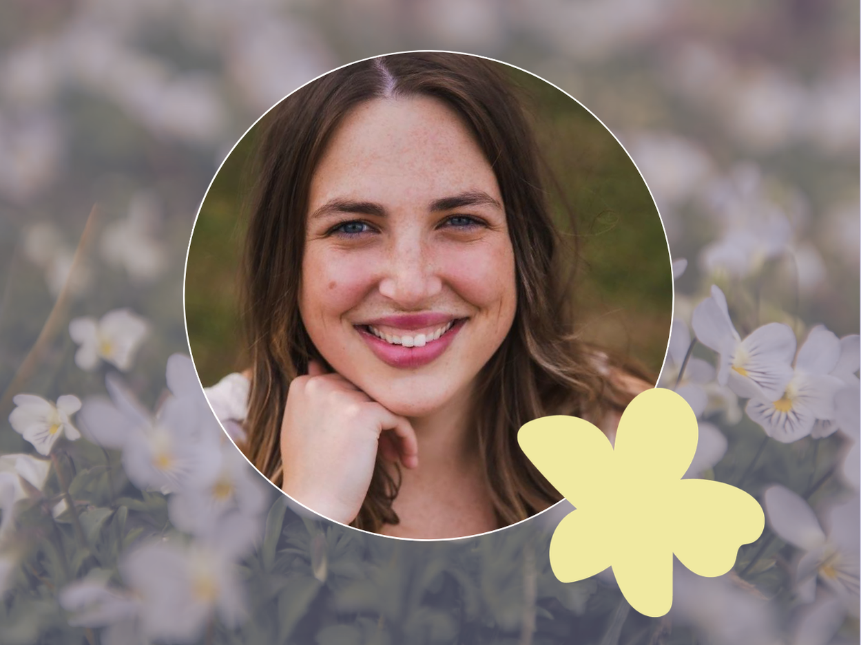 Picture of therapist smiling with flowers around