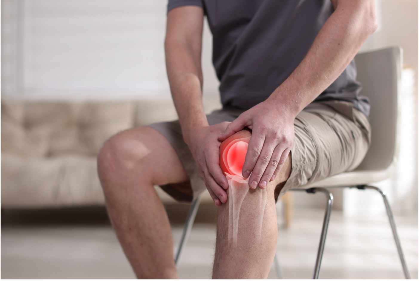 A male patient is sitting in a chair wearing a gray shirt and khaki shorts. His right knee is highlighted in red indicating pain while he holds it with both hands. A text box says "Patellar Tendinitis"