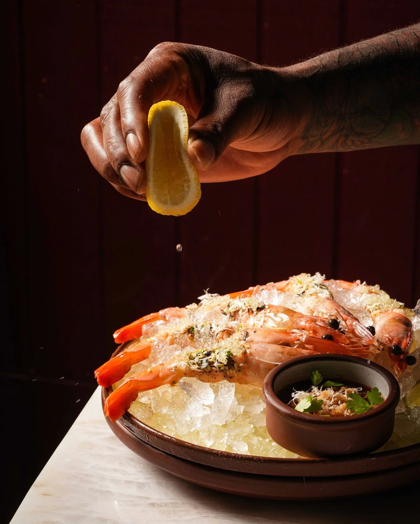 Squeeze that lemon on top of our Caledonia Prawn Cocktail to enhance the flavor. We serve it with sauce creole, furikake, and horseradish intentionally. It&rsquo;s impossible to eat it quietly! #LasLapMiami