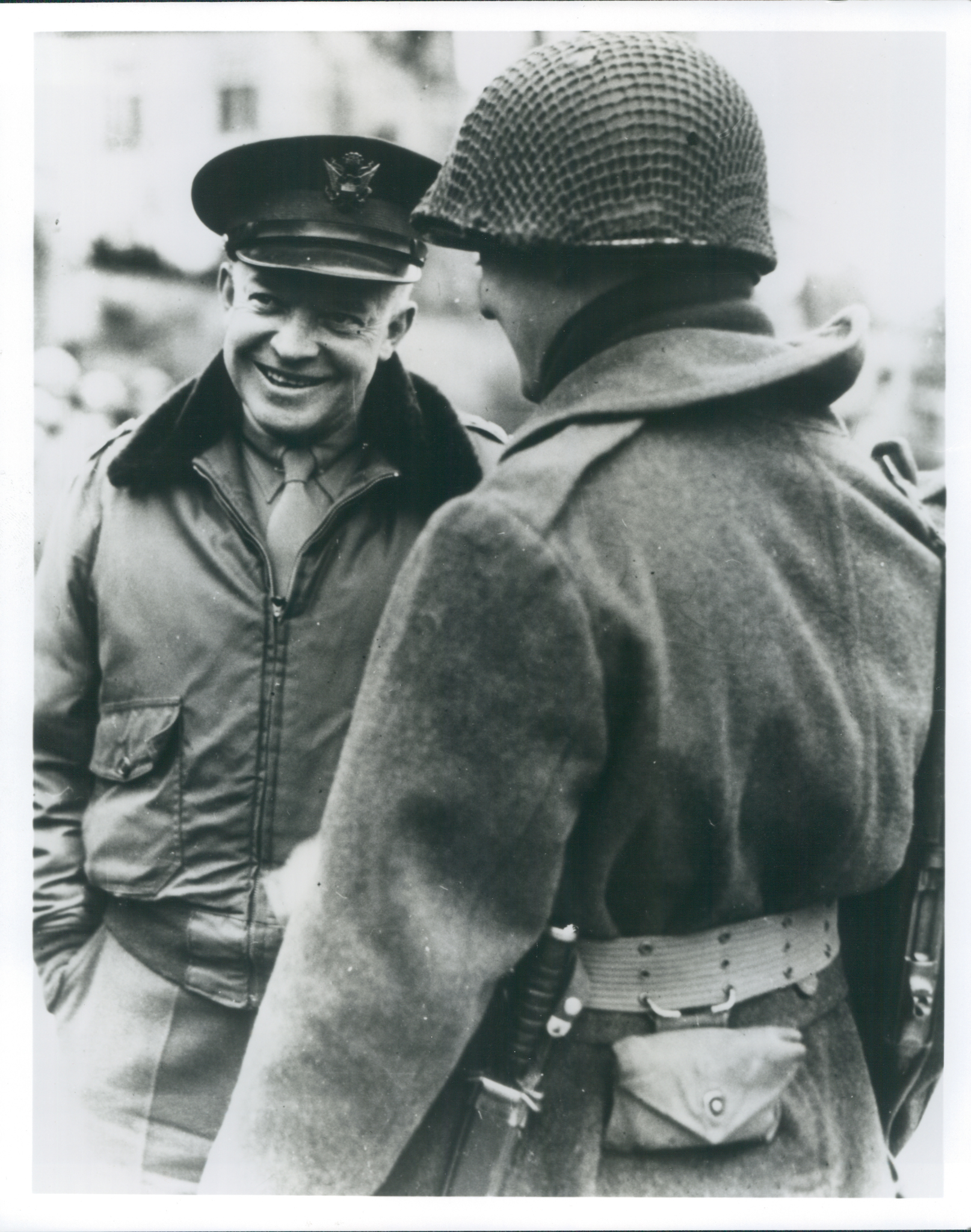 Photo of Dwight D. Eisenhower smiling while speaking to a solder