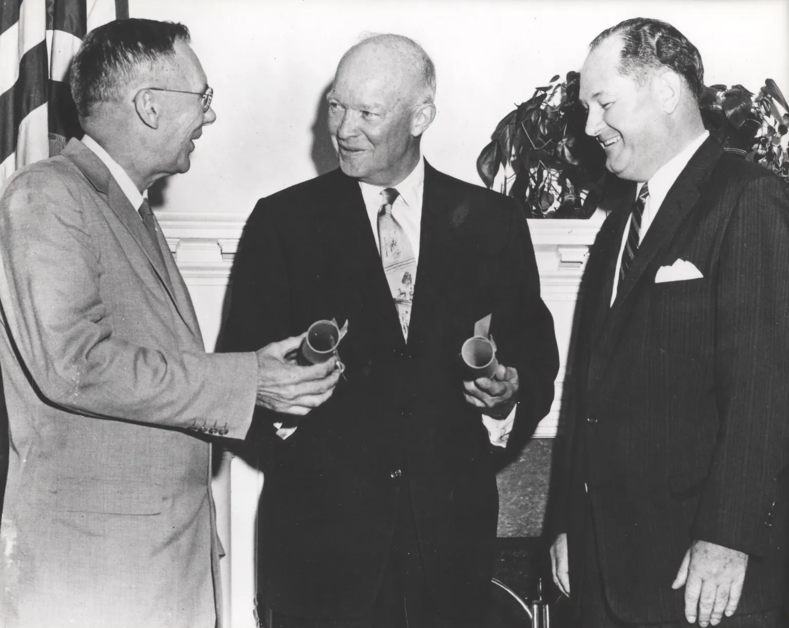 A black and white photo of President Eisenhower speaking to two individuals