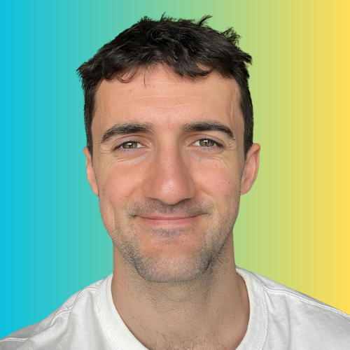 Close-up of a smiling man with short dark hair, wearing a white shirt, against a gradient background of teal to yellow.