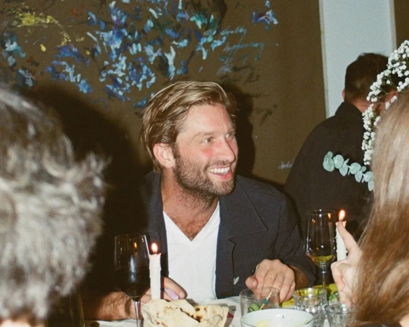 Experiential Creative Director Nate Long smiling at a dinner gathering