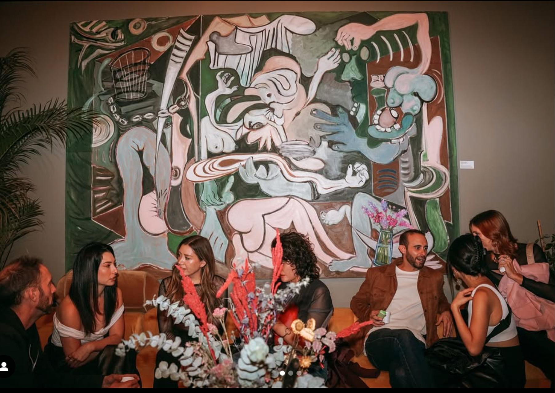 Guests gathered beneath a large artwork during a dinner at Call Me Lola in Mexico City.