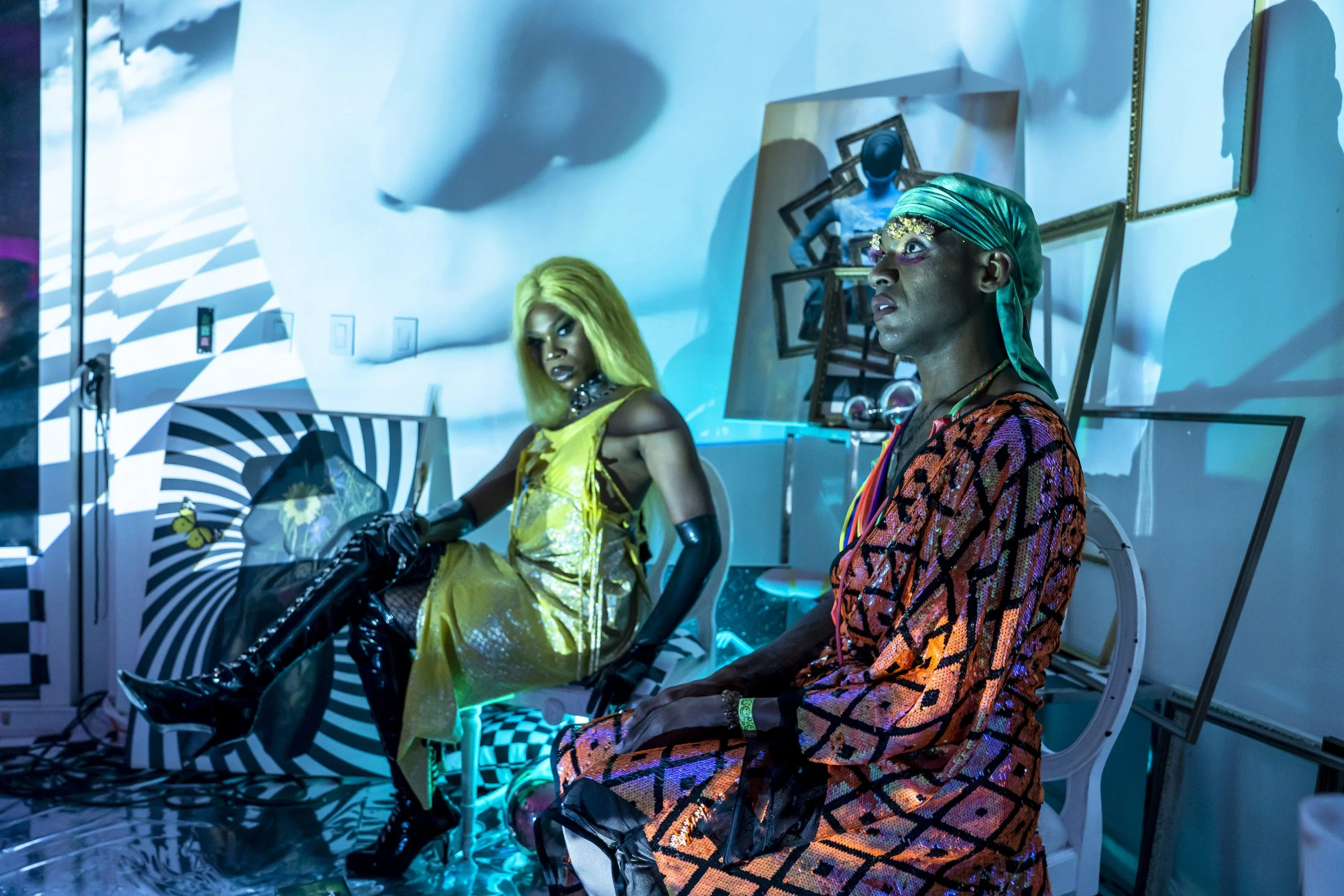 Guests inside the Pew Pew Miami cultural pop-up surrounded by immersive art, projection and colorful lighting.