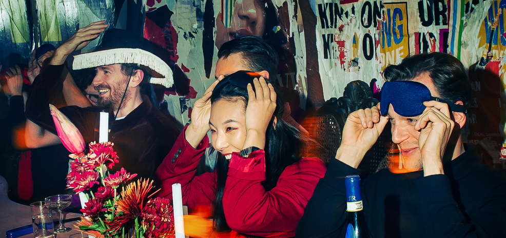 Guests adjusting blindfolds during Pew Pew's immersive multisensory dining experience