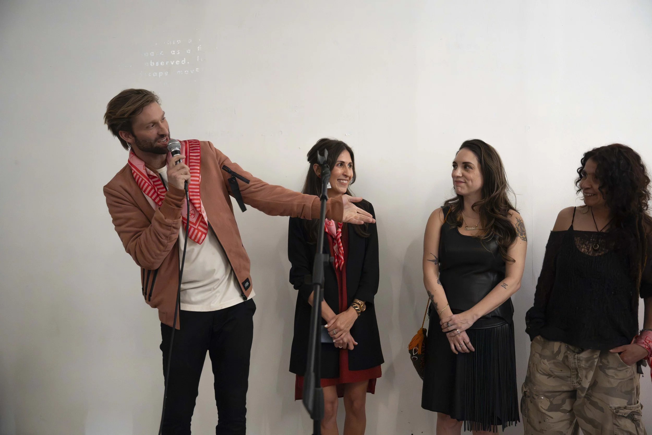 Creative lead, Nate Long, speaking with three collaborators during a live presentation.