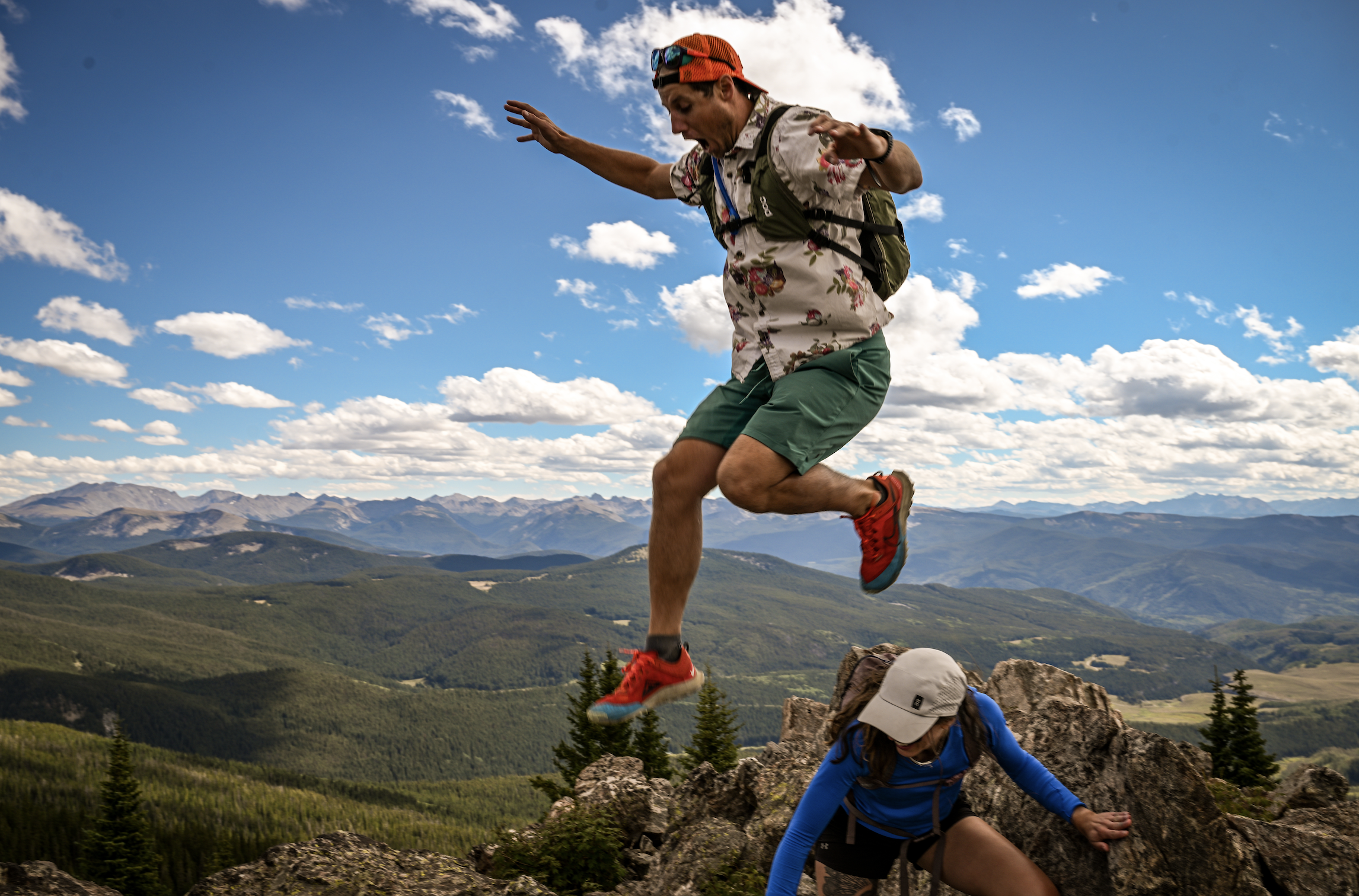 A man jumping on a mountain peak, representing strength, freedom, and the breakthroughs achieved at Recovery and Wellness Services.