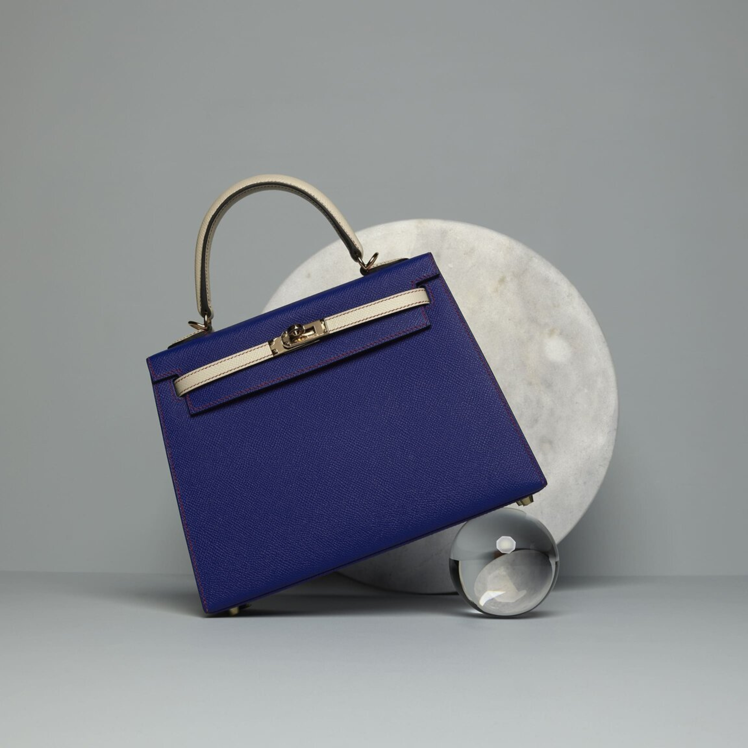 Bespoke, one-off Hermès Kelly 25 in electric blue and chalk colourway and a horseshoe stamp.
