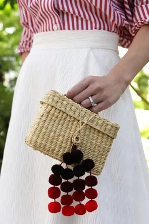 Influencer carrying Nannacay pom pom bag