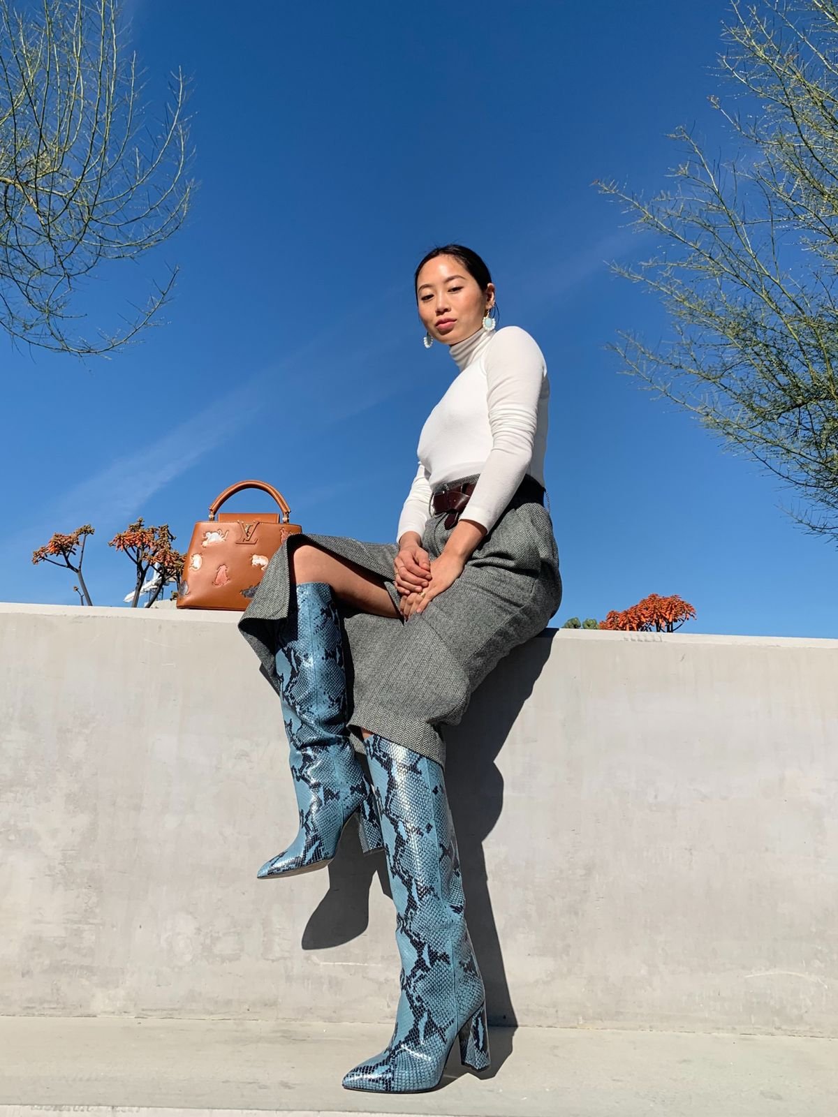 Talent wearing Paris Texas boots outdoors against the blue sky