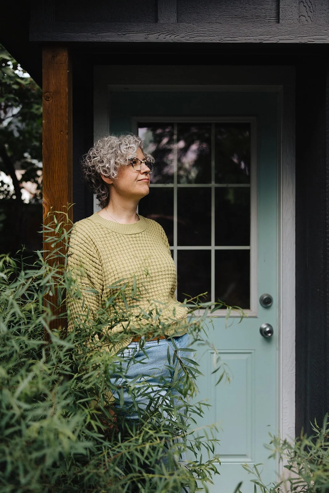 Isabel Prystawik leaning in doorway, looking into the distance