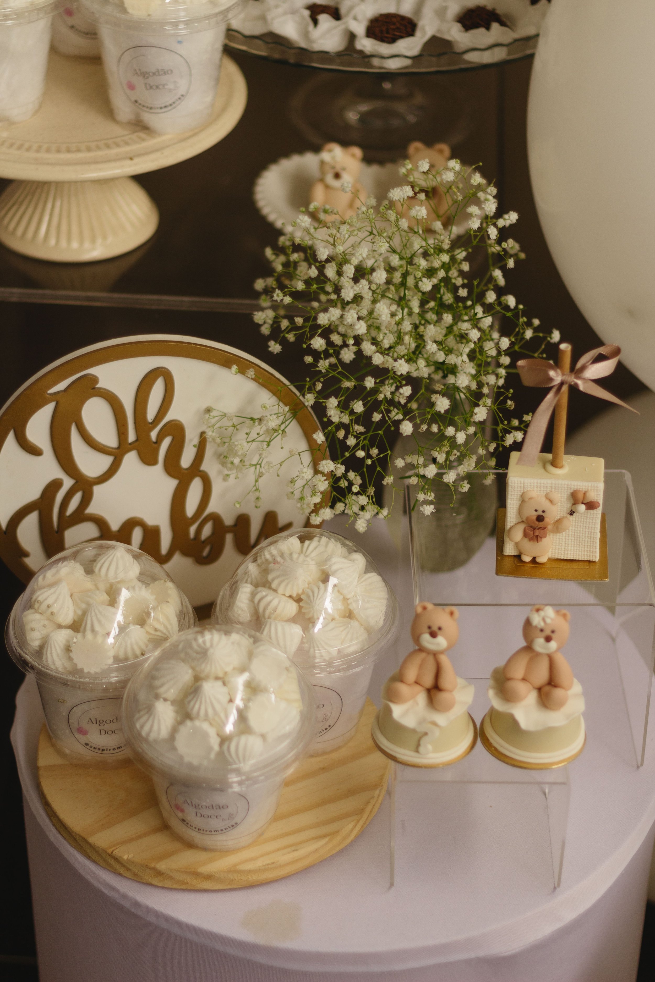pastries, flowers and baby shower decor on table