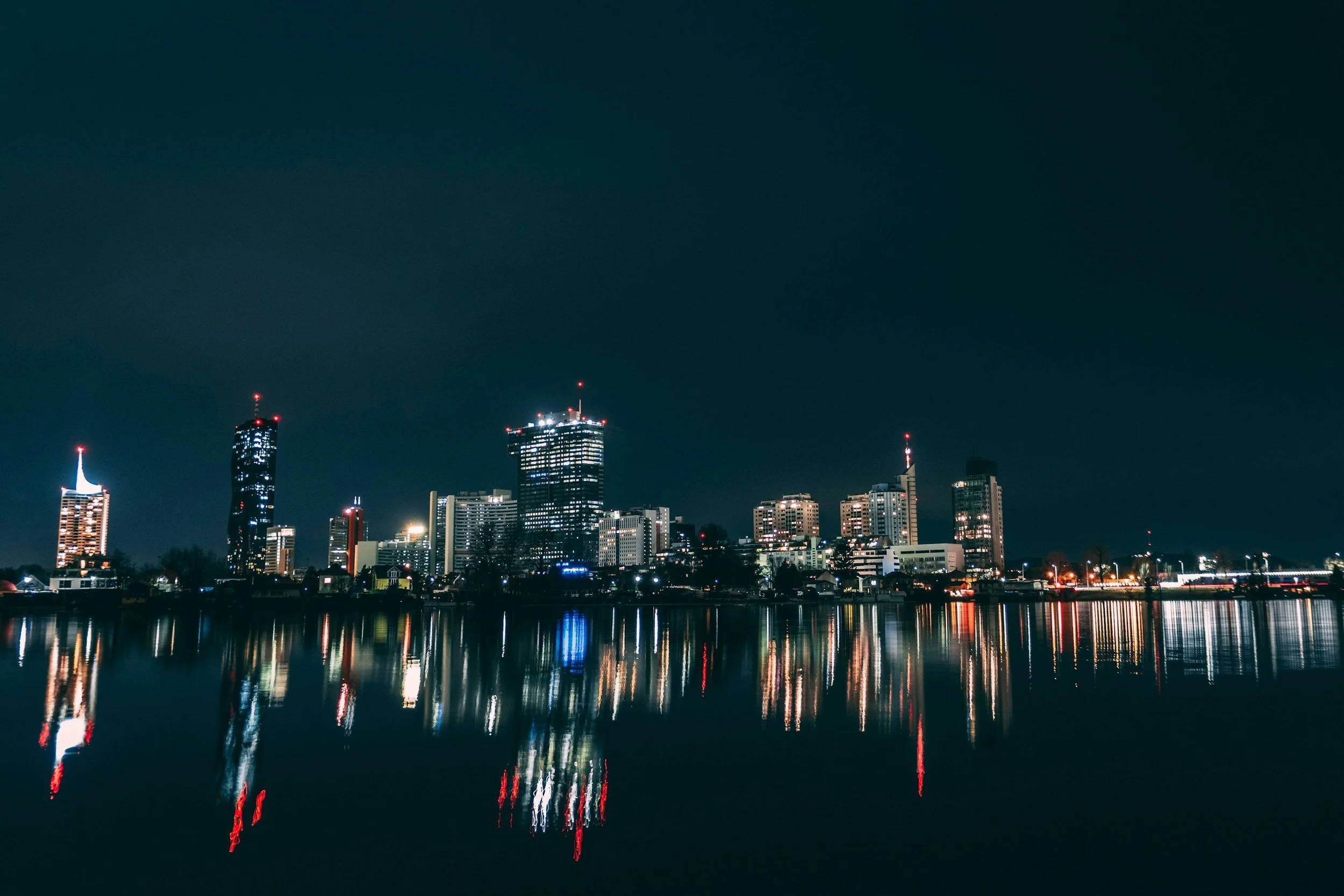 Nighttime city skyline reflected on a river