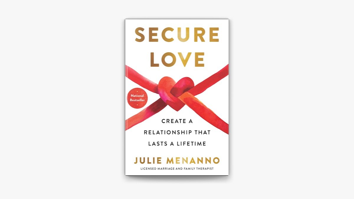 Book cover titled 'Secure Love' by Julie Menanno, featuring a red heart-shaped knot with two red ribbons intertwined, and a red sticker indicating it is a national bestseller.