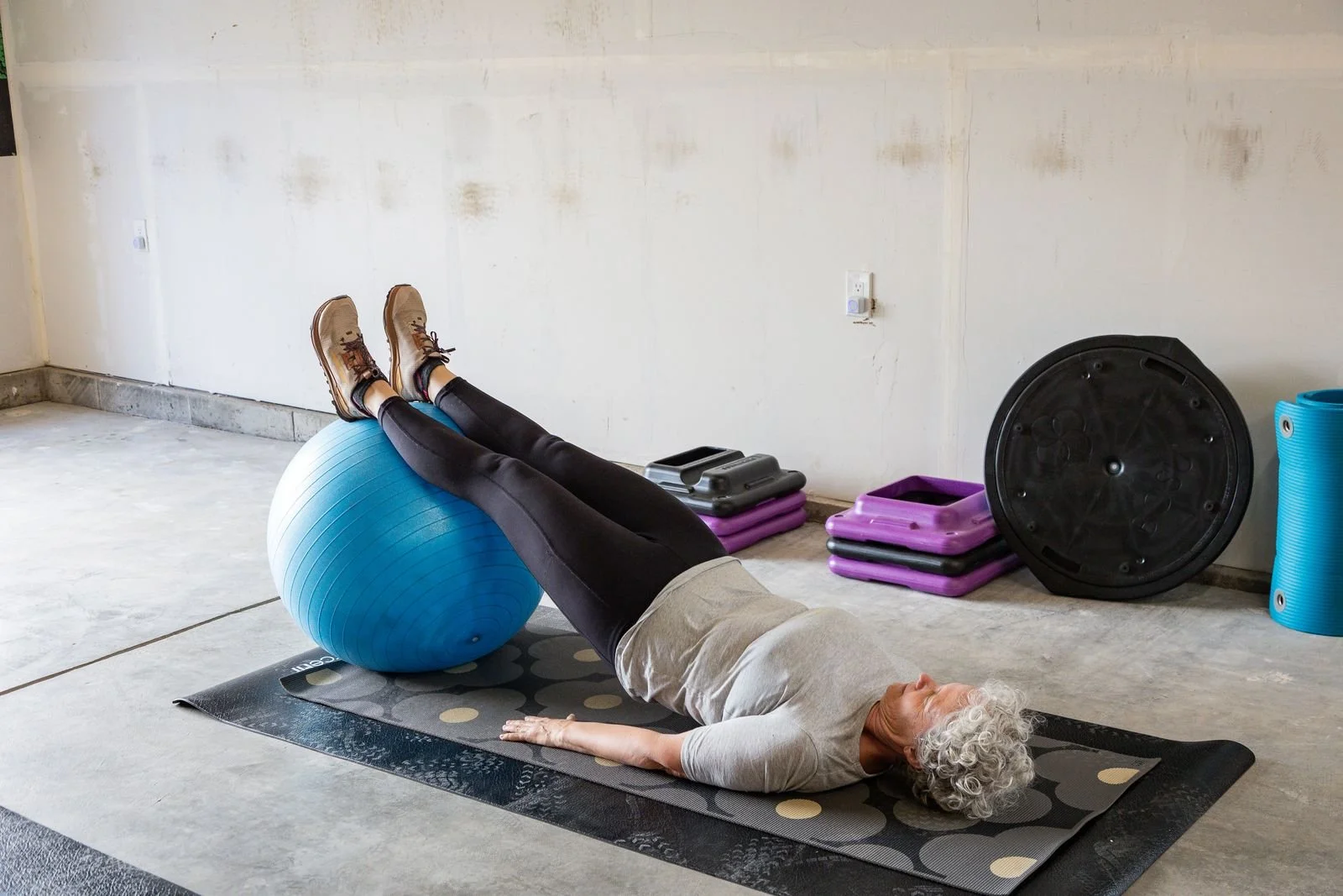 a woman balancing on a ball