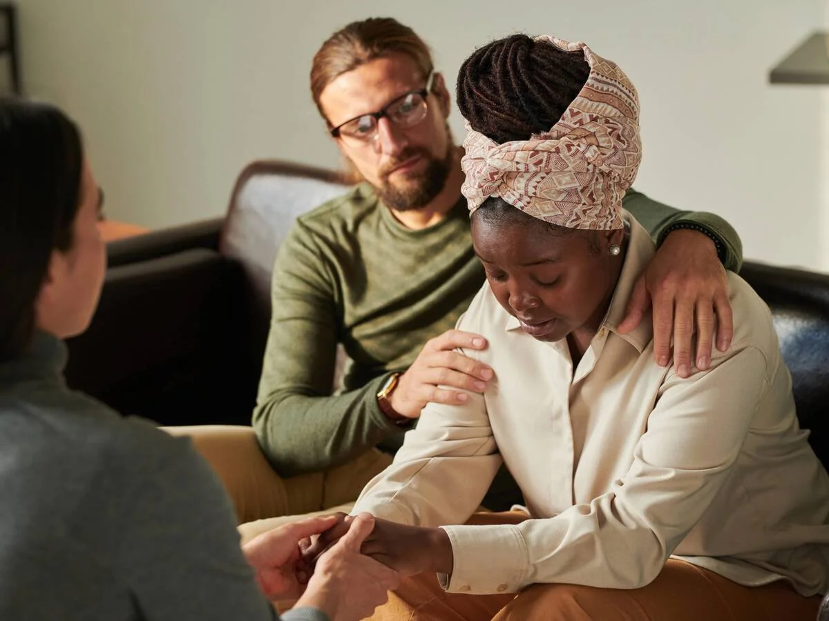 Couple sitting together after conflict, reflecting and preparing to reconnect