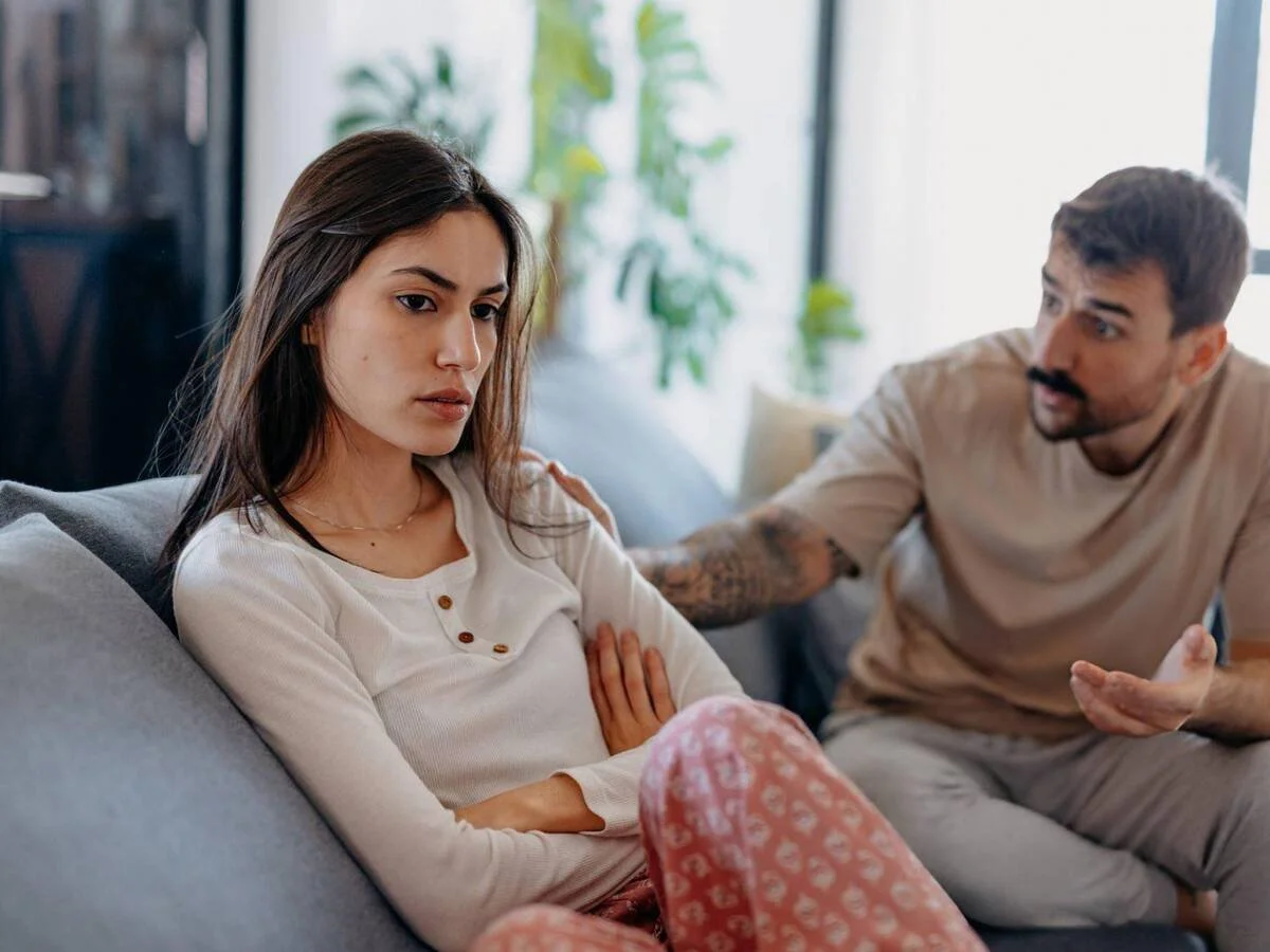 Couple caught in a pursue-withdraw relationship cycle during an emotional conversation.