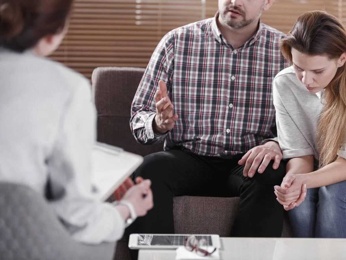 Couple experiencing quiet tension during an everyday moment, representing common relationship conflict