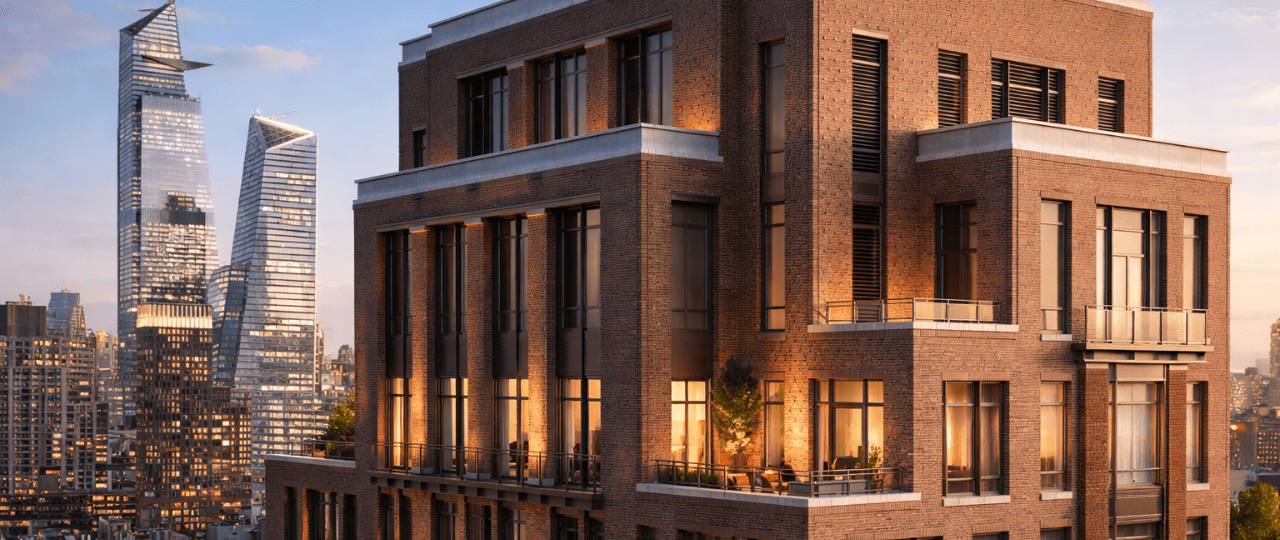 Modern commercial building in New York City with illuminated windows and skyline backdrop.