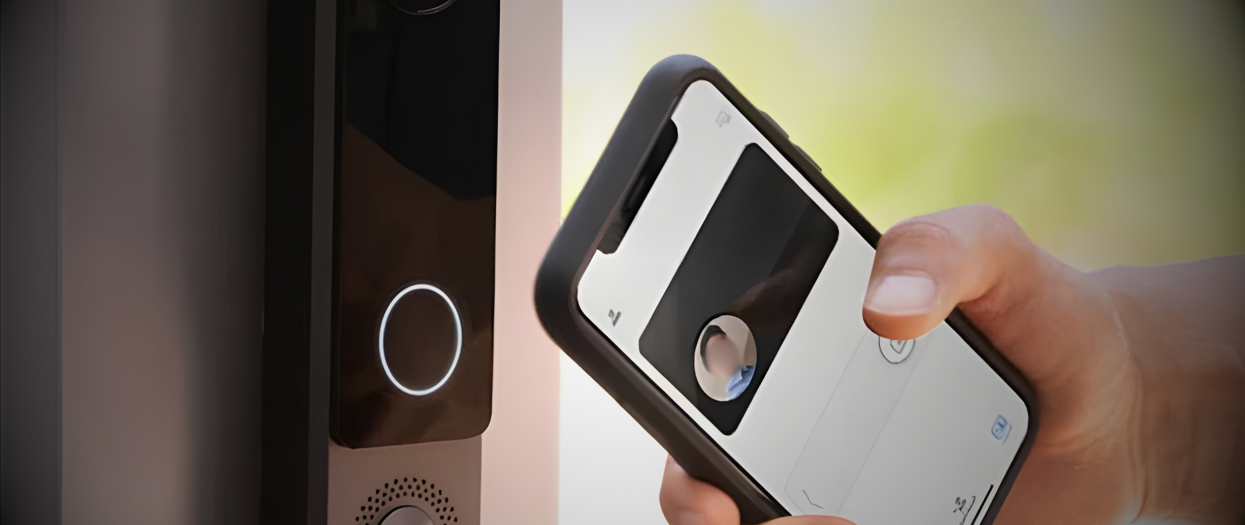 User unlocking a video intercom door with a smartphone, demonstrating integrated access control and mobile security systems.