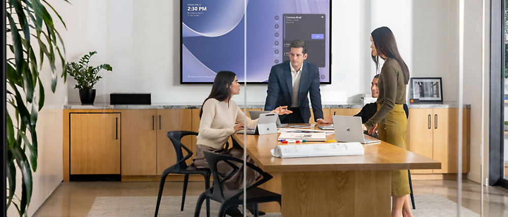 Business team collaborating in a modern office while upgrading legacy systems to cloud-based security solutions and integrated digital infrastructure.