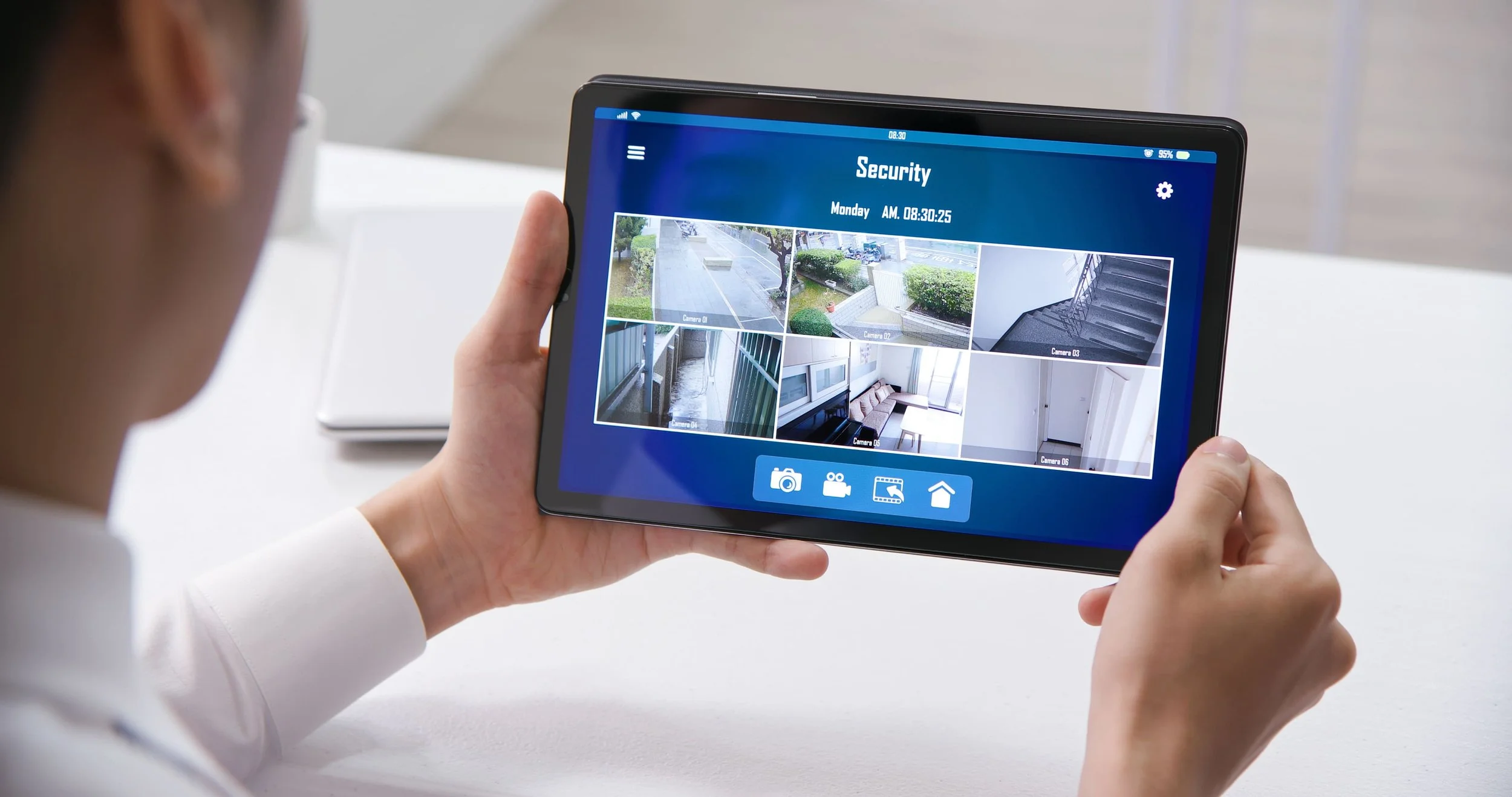 User monitoring customized security system with multiple surveillance feeds on a digital dashboard