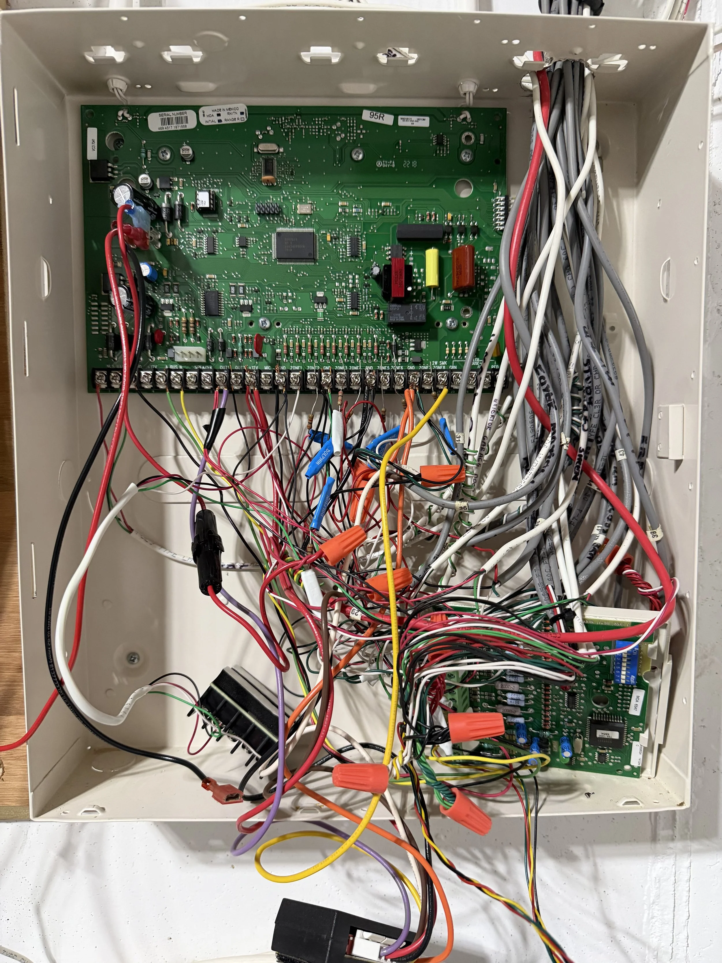 Before Picture of Messy Alarm Panel with wires running everywhere