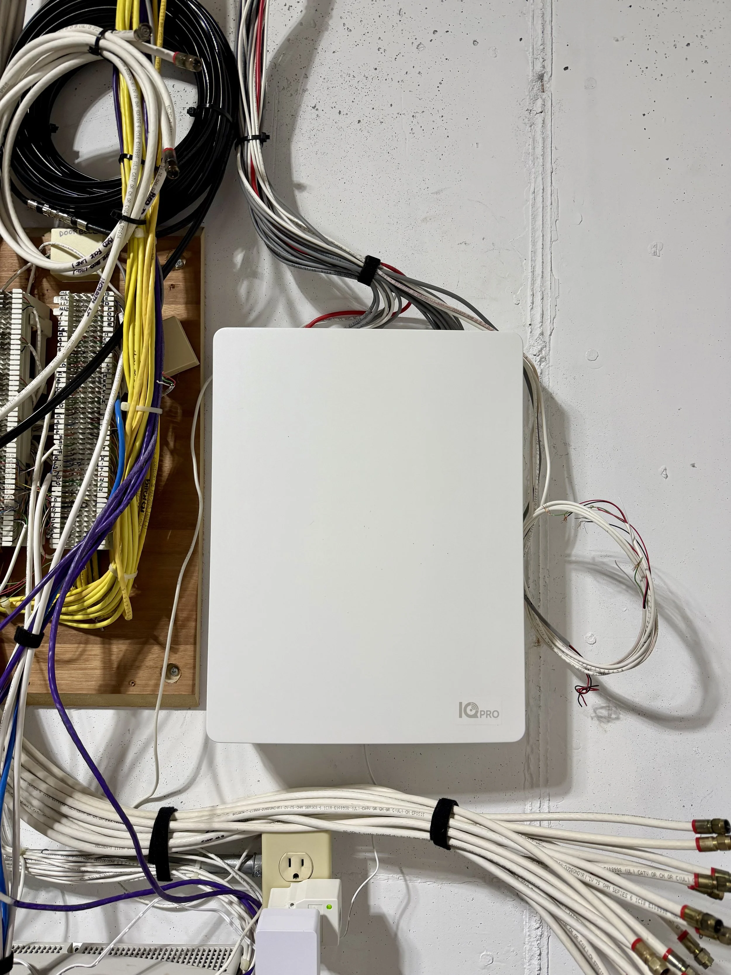 White, hardwired cellular backup alarm panel installed on wall