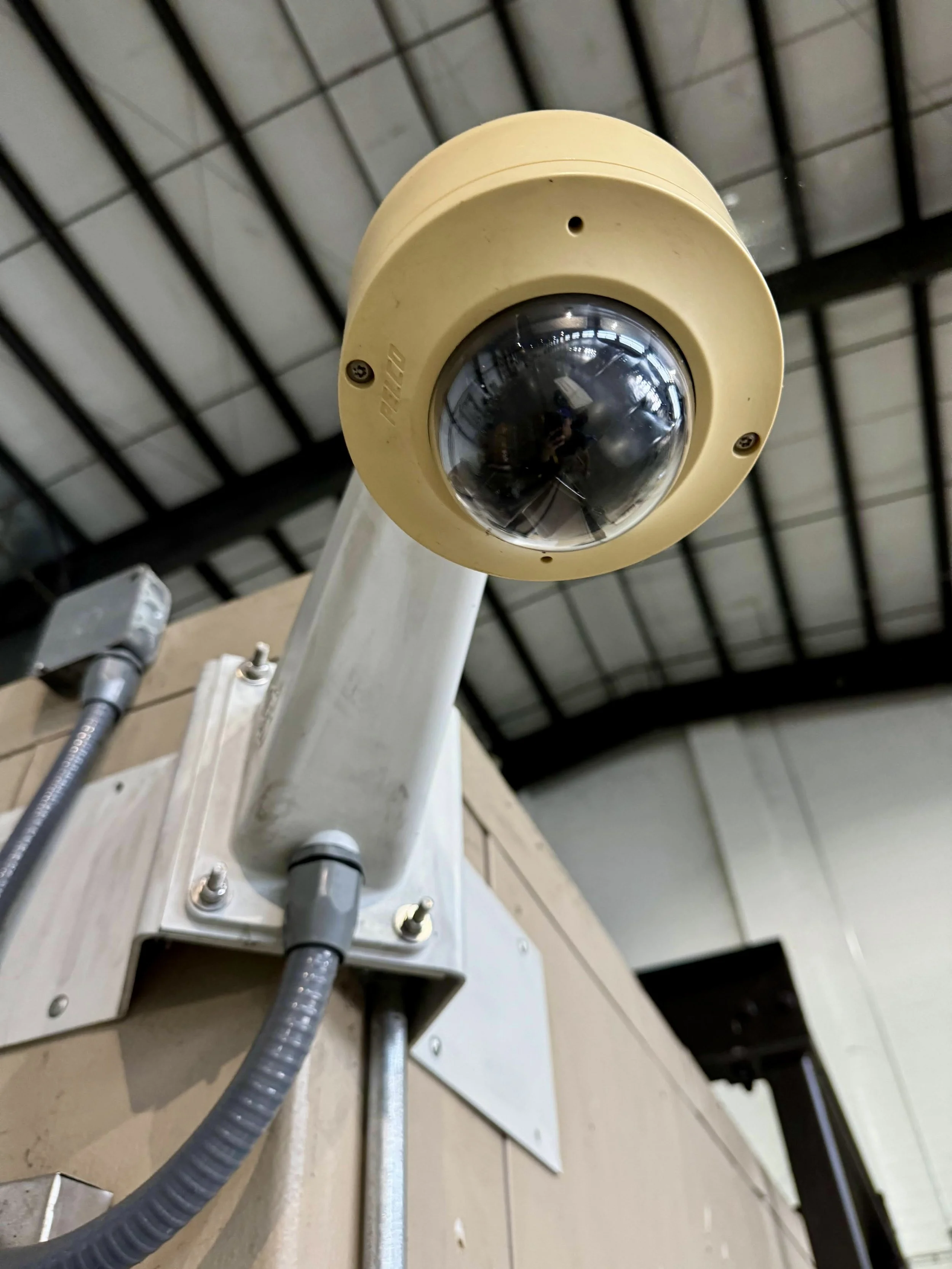 Pelco security camera mounted to corner of building