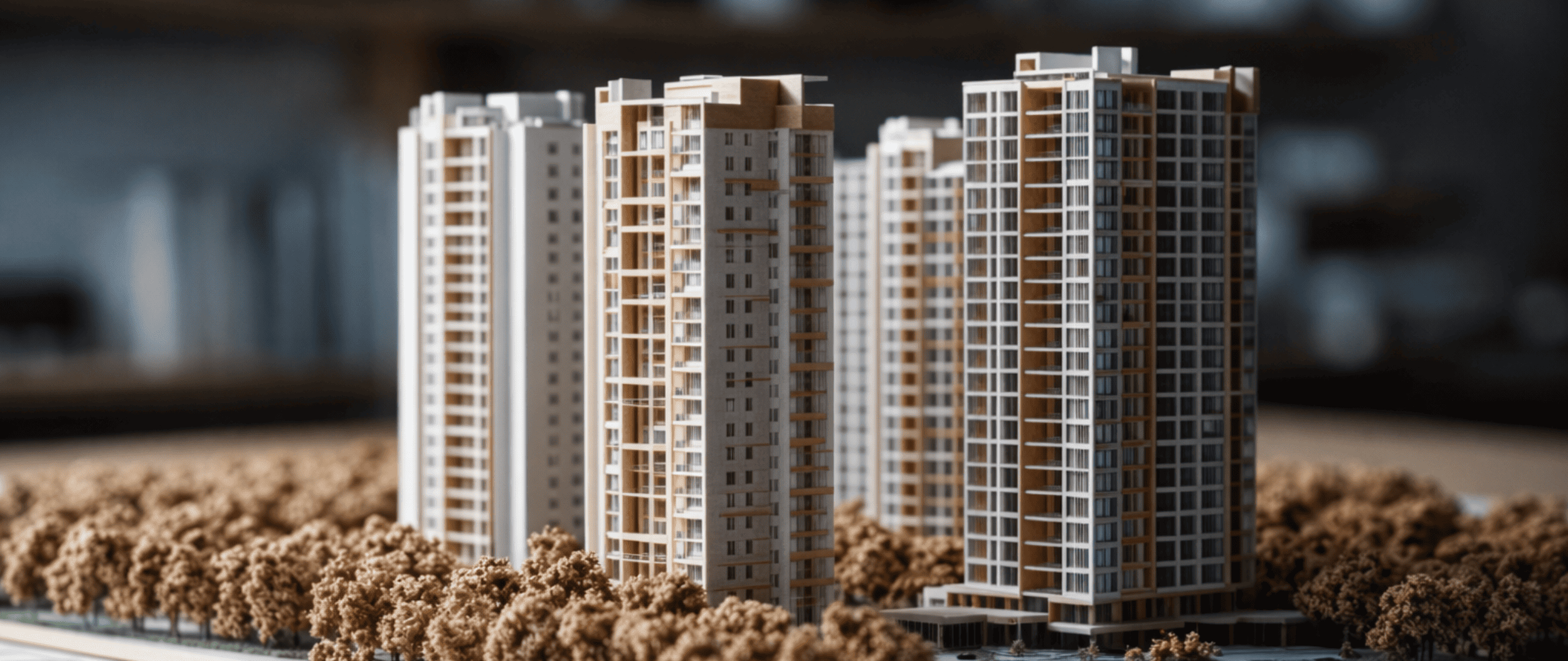 Scale model of modern high-rise residential buildings representing multifamily property development.