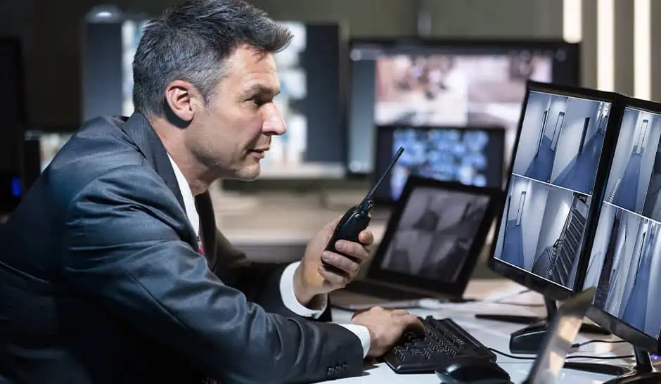 Security personnel and surveillance systems ensuring safety at a place of worship during a public gathering.
