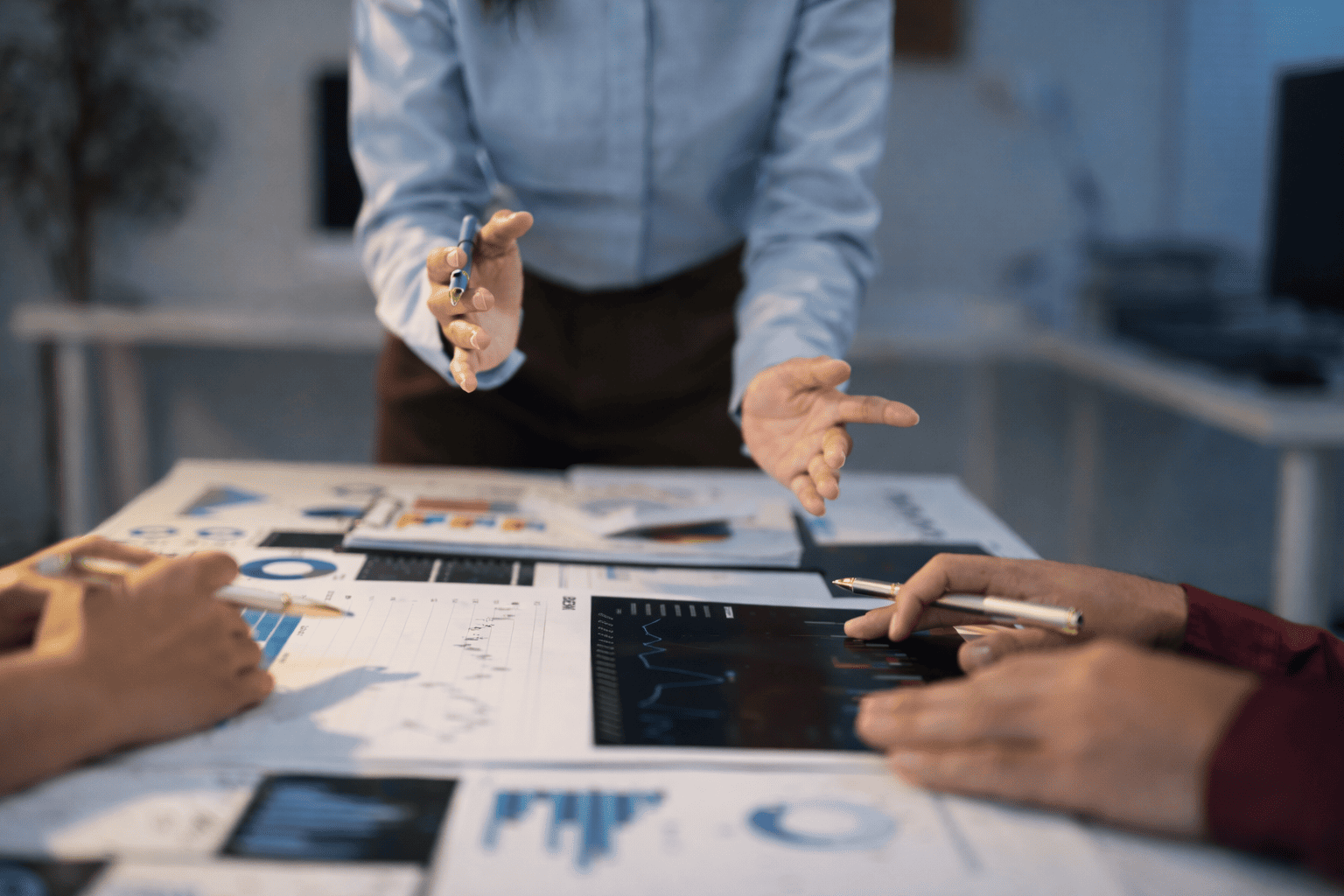 Security professionals reviewing risk assessment data and performance charts during a strategy meeting.
