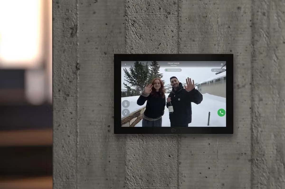 Wall-mounted Josh AI touch panel showing a live front door camera view with incoming call, door lock, and lighting controls.