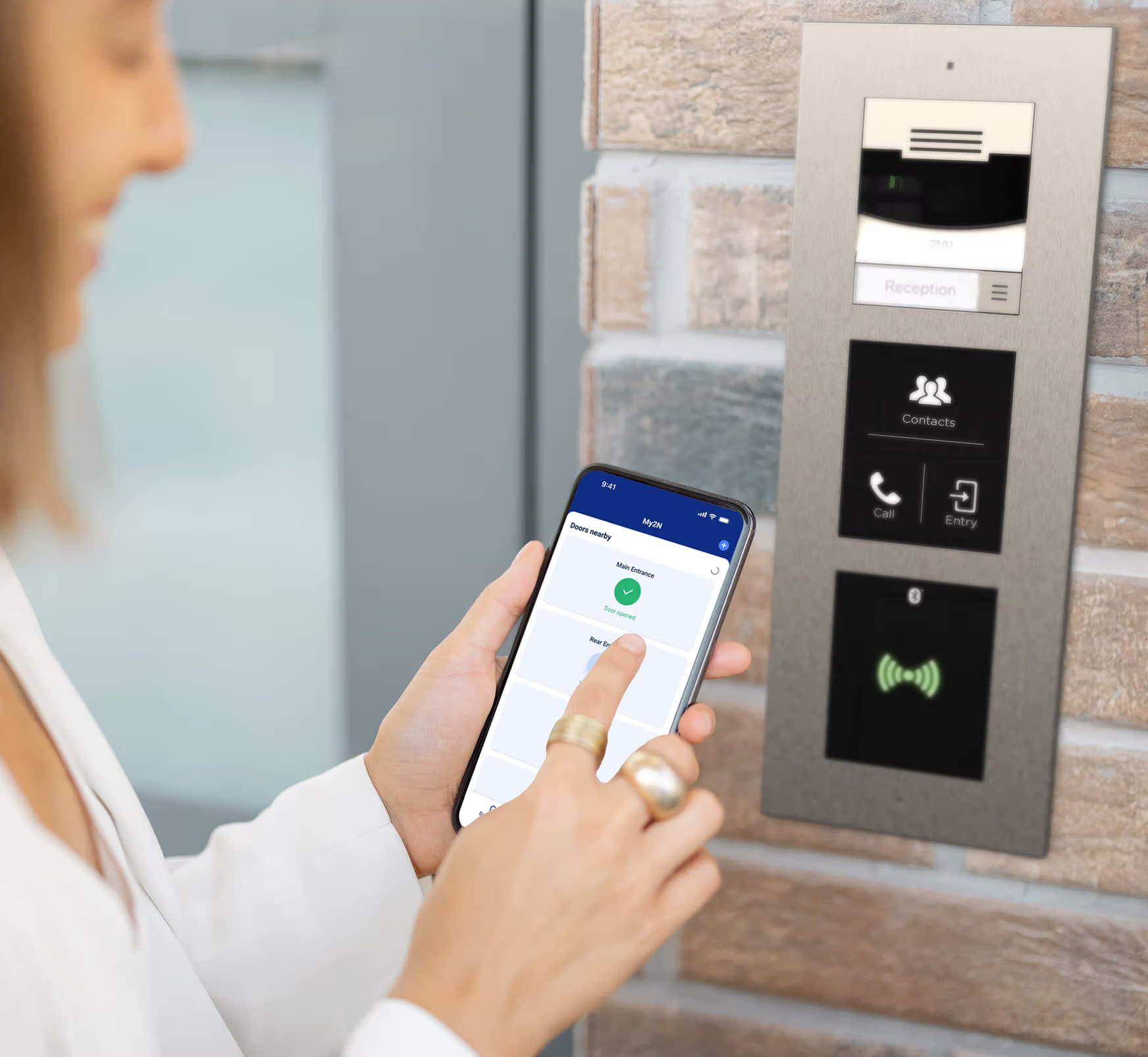 User unlocking a building door via mobile app connected to a video intercom access control system.